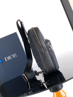 Dior mini crossbody bag side view with silver-tone buckle hardware and top zip
