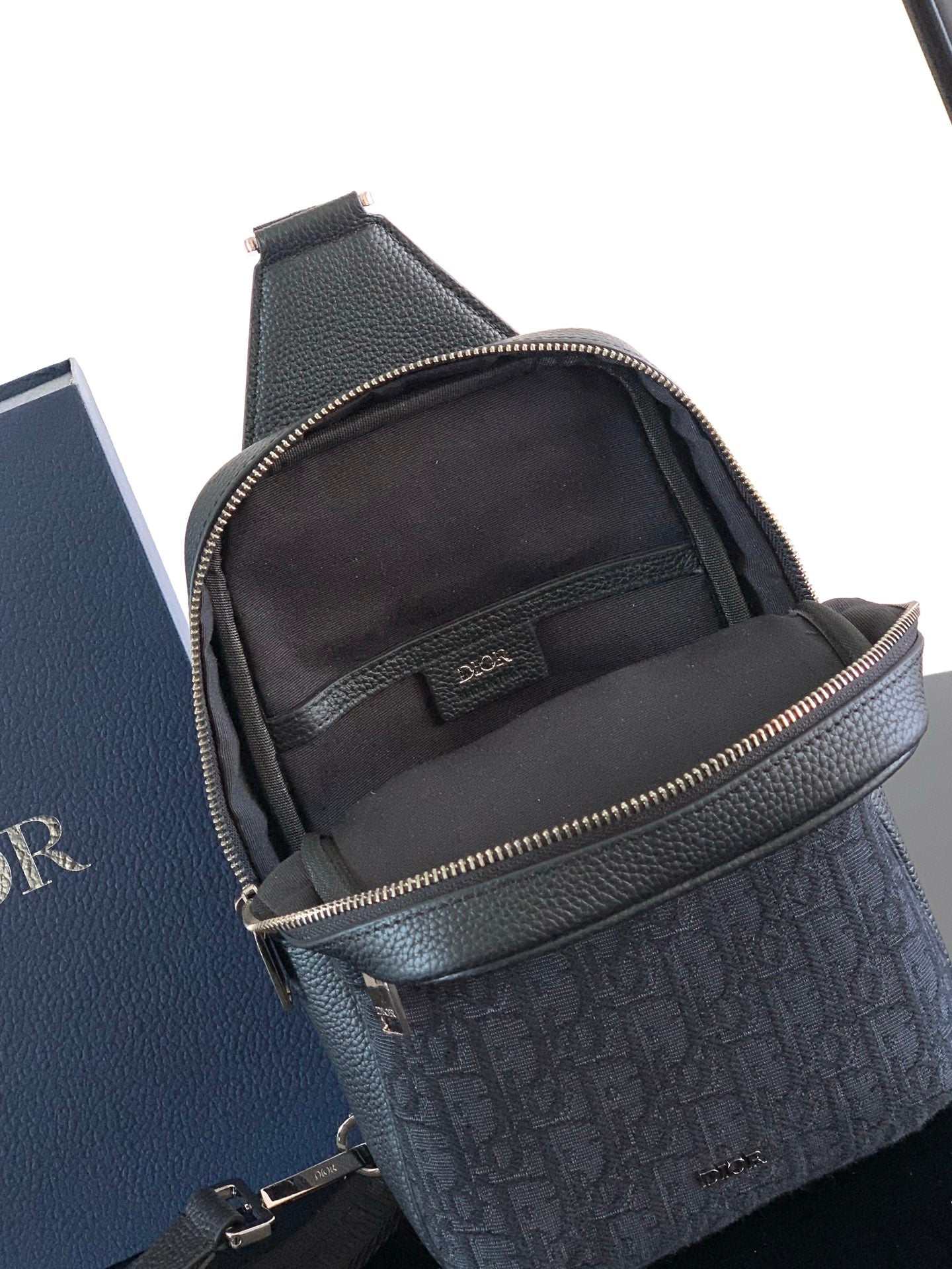 Dior mini crossbody bag front view with monogram panel, top zip, and adjustable strap