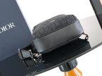 Dior mini crossbody bag with curved top zip and dark grained leather front