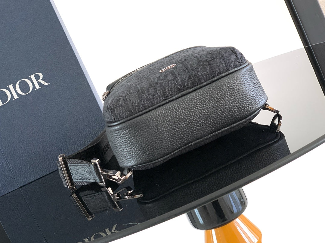 Dior mini crossbody bag with curved top zip and dark grained leather front