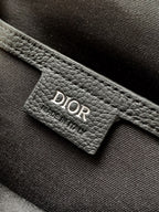 Dior mini crossbody bag interior tag with Dior logo on dark leather lining