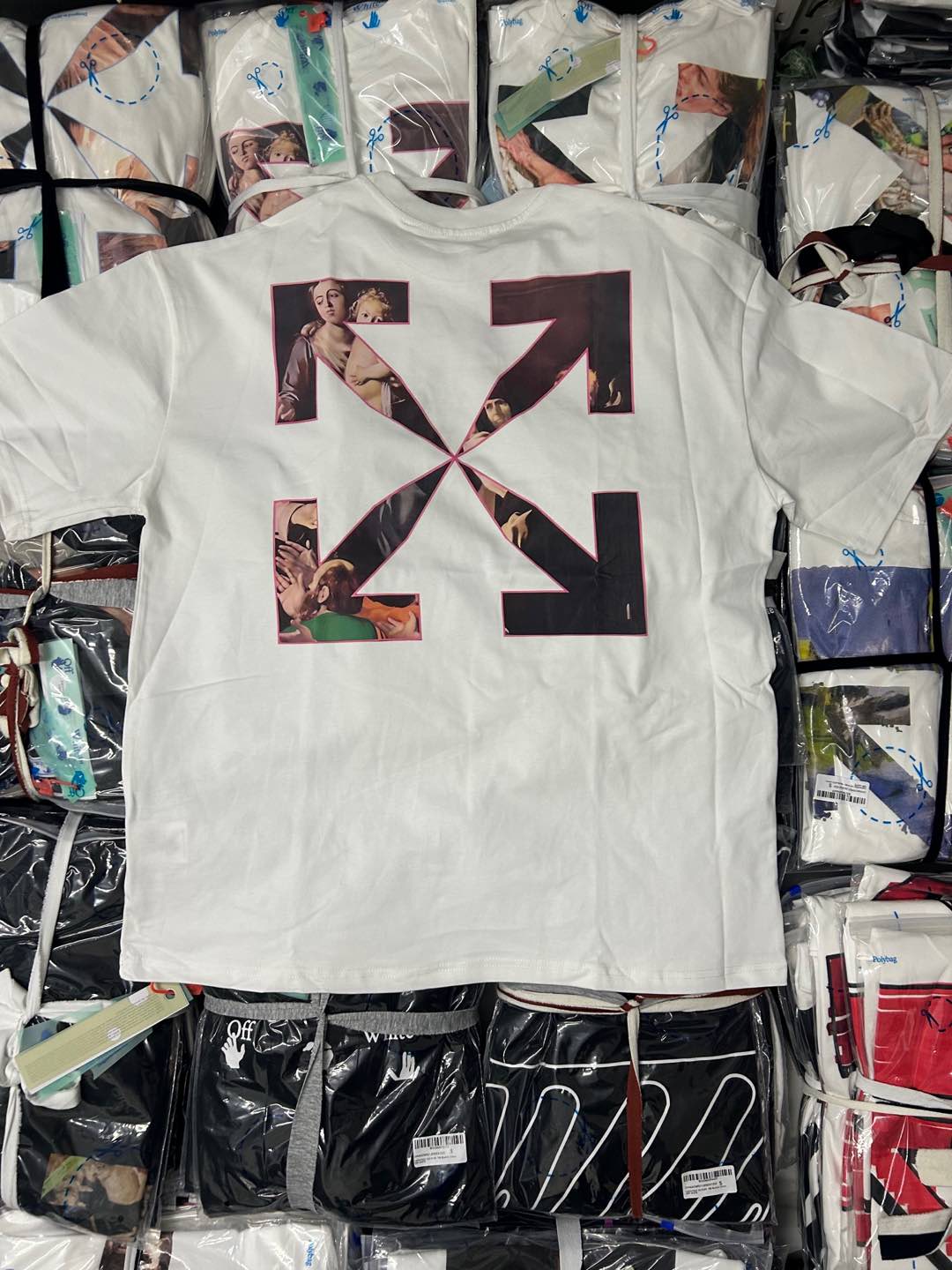 Graphic T-shirt with large multicolor X-style collage lettering on the front