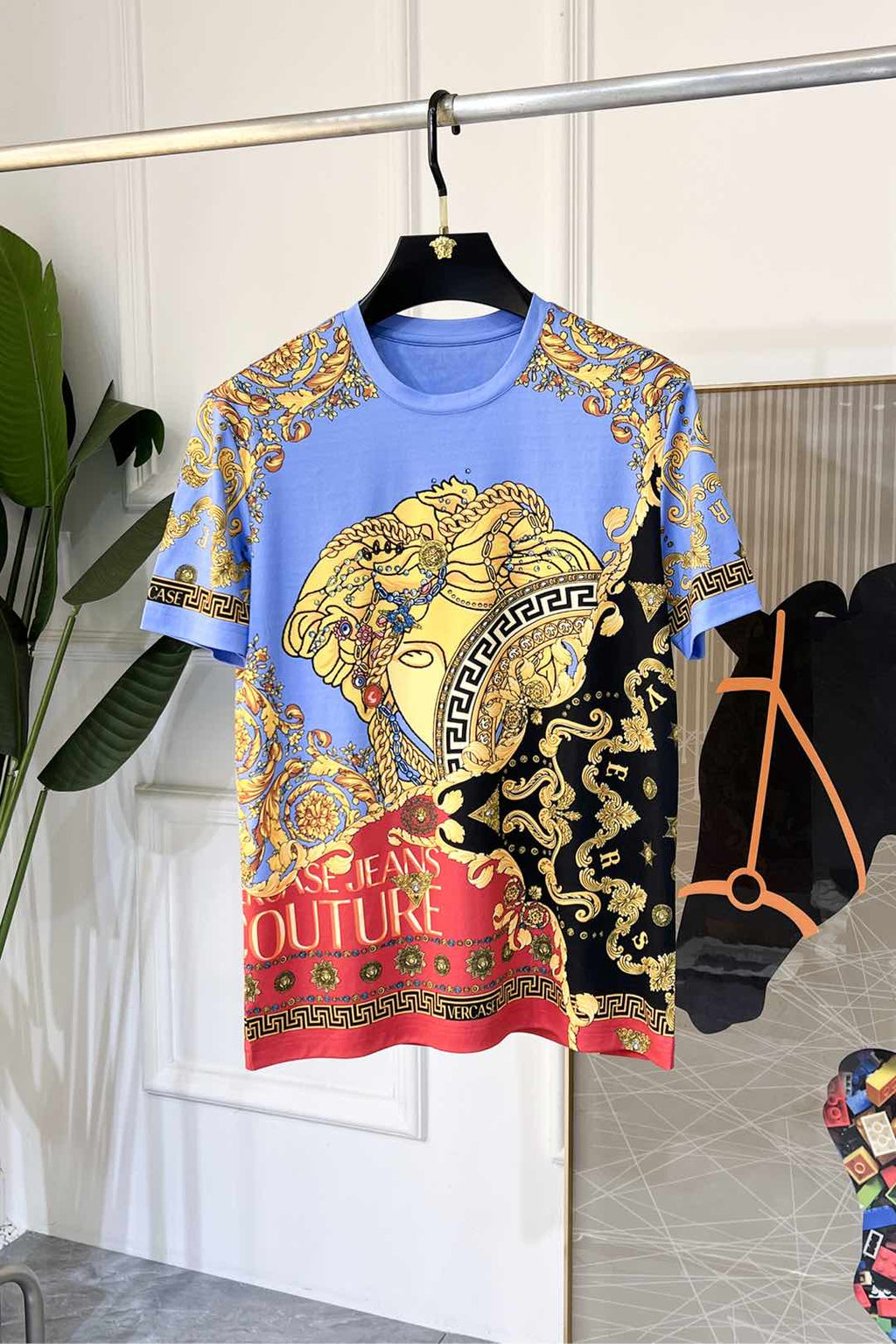 Crewneck T-shirt in light blue with gold, black, and red Versace-style baroque print