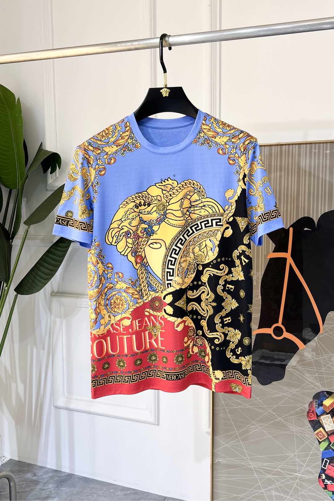 Crewneck T-shirt in light blue with gold, black, and red Versace-style baroque print