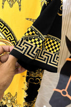 Graphic T-shirt sleeve cuff with black-and-gold trim and checkerboard pattern