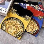 Graphic T-shirts showing yellow, red, and blue Medusa-style prints, folded