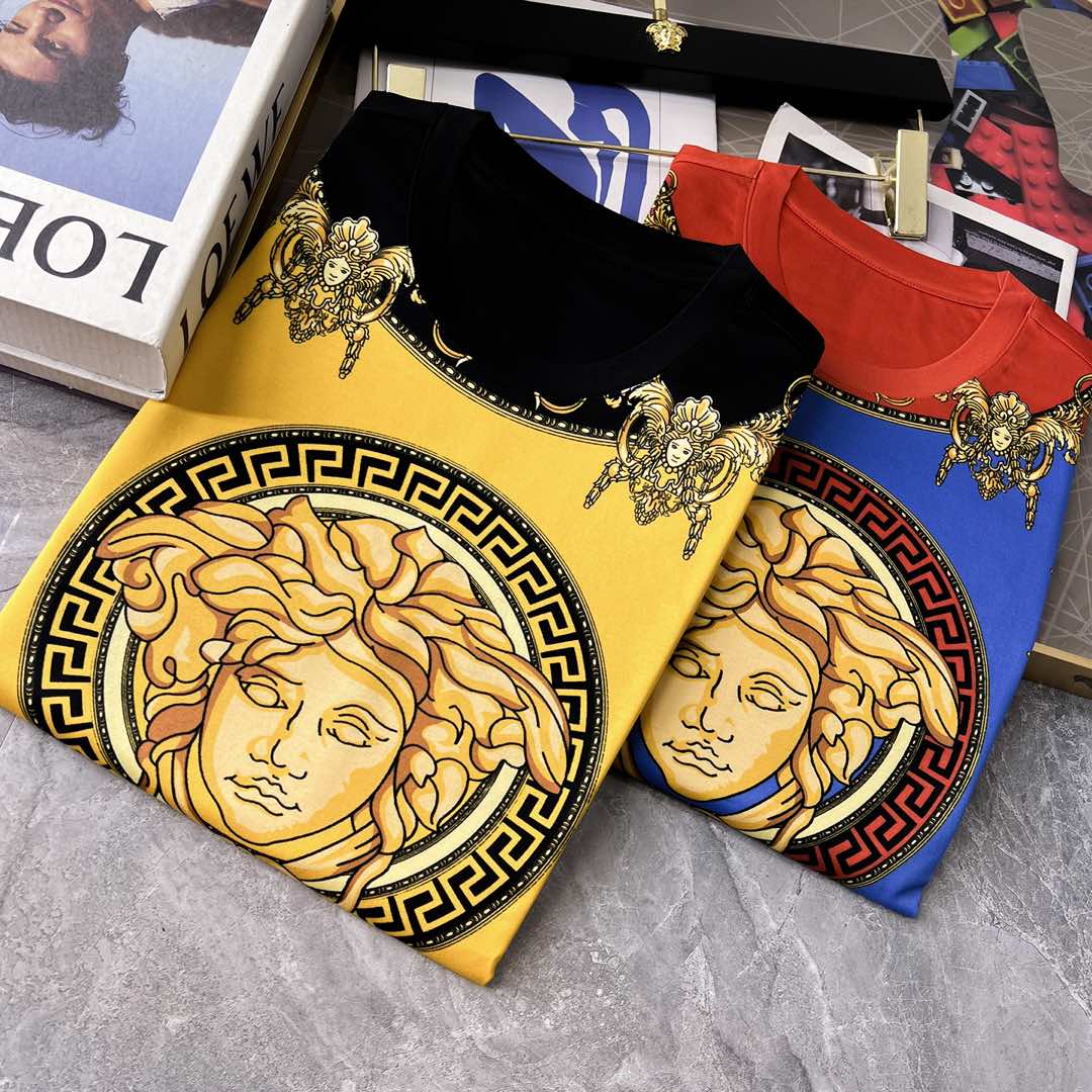 Graphic T-shirts showing yellow, red, and blue Medusa-style prints, folded