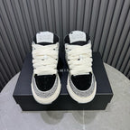 Back view of black and white sneakers on box, showing heel and ankle