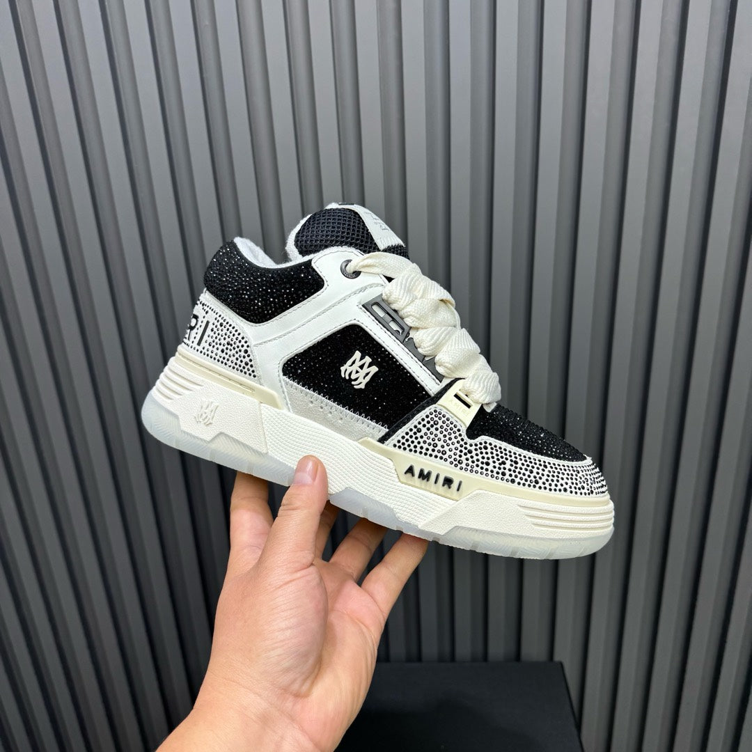 Black and white low-top sneakers with chunky sole and side logo