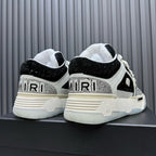 Black and white sneakers viewed from back, showing heel branding