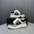 Black and white sneakers on a box in angled view, lace-up front
