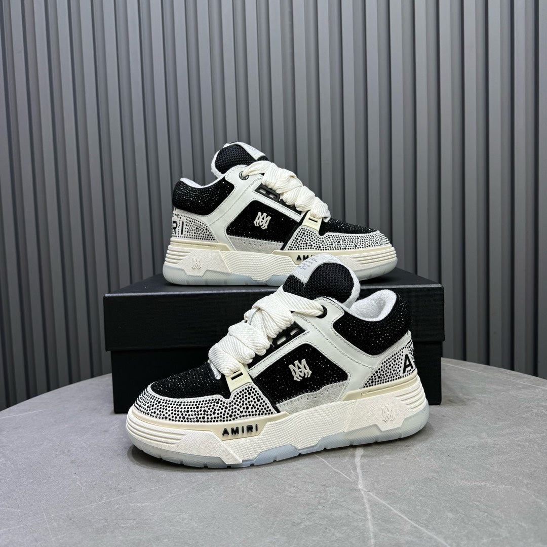 Black and white sneakers on a box in angled view, lace-up front