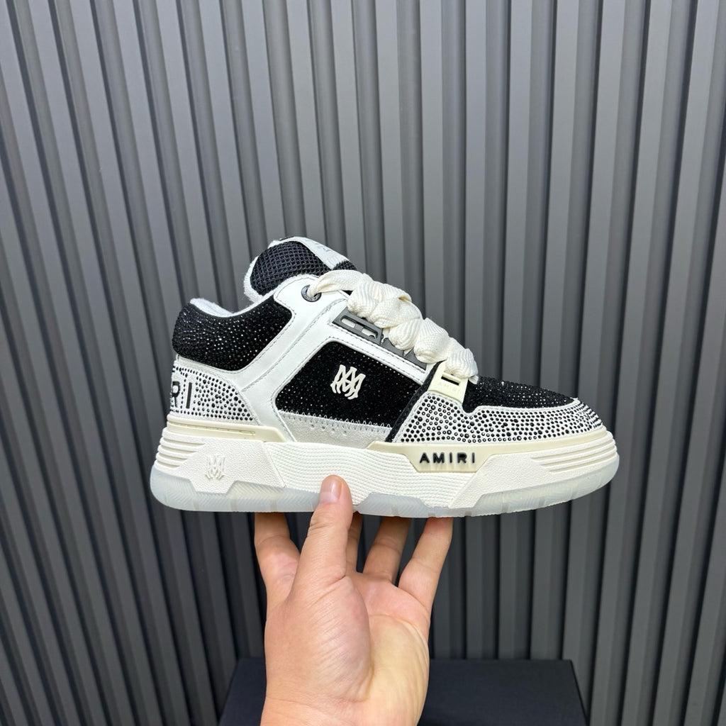 Black and white sneakers with white laces and AMIRI logo on the side