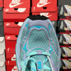Teal and lavender sneaker upper close-up with lace eyelets and mesh detail