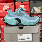 Teal and lavender athletic sneaker side view with textured mesh panels and laces