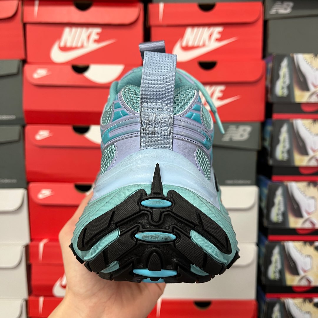 Teal and lavender sneaker outsole view with black and turquoise traction pattern