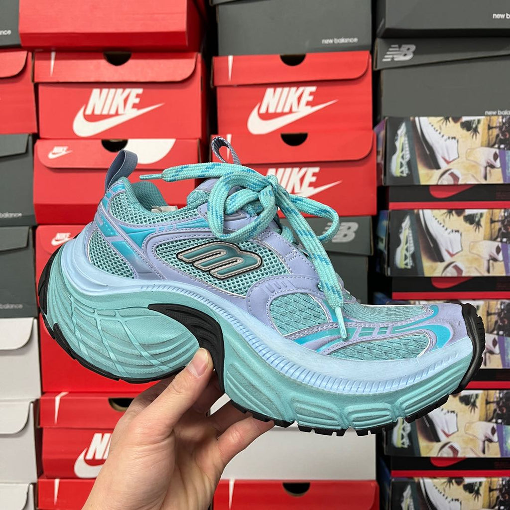 Turquoise and lavender athletic sneaker front three-quarter view with matching laces