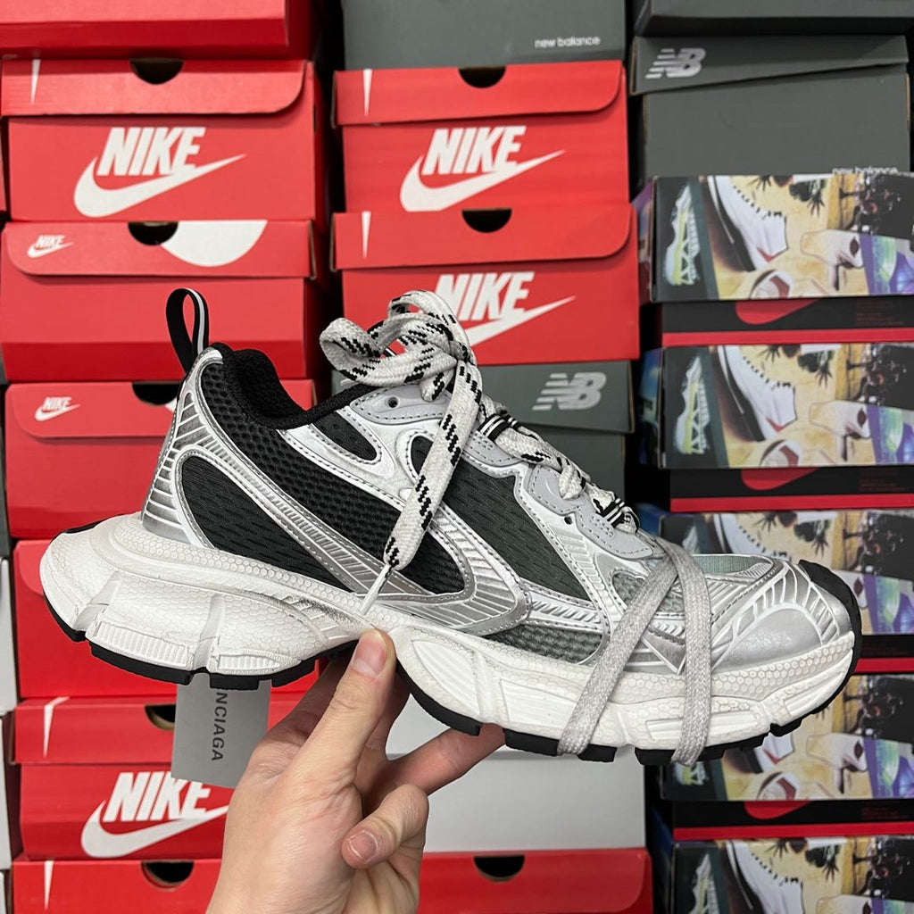 Full side view of silver and black lace-up sneakers with thick white sole