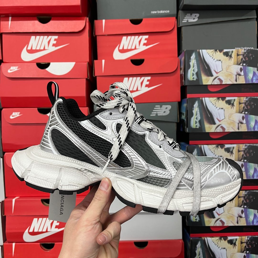 Full side view of silver and black lace-up sneakers with thick white sole