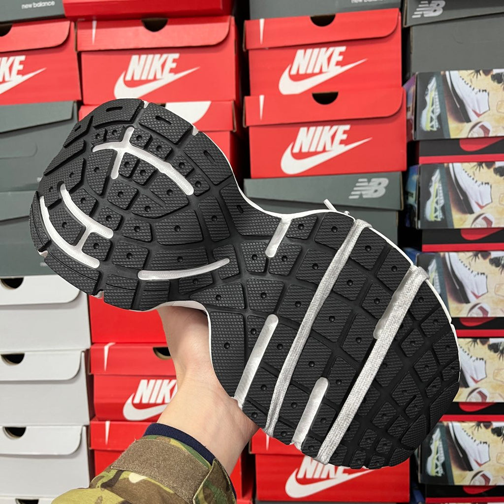 Outsole view of black traction tread with white sidewall on chunky sneakers