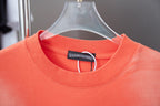 Coral orange crewneck T-shirt neckline with interior label and short sleeves