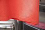 Coral orange short-sleeve T-shirt hem and stitching detail