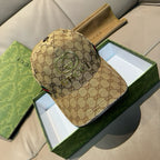 Gucci cap in tan GG monogram canvas with green web stripe and curved brim