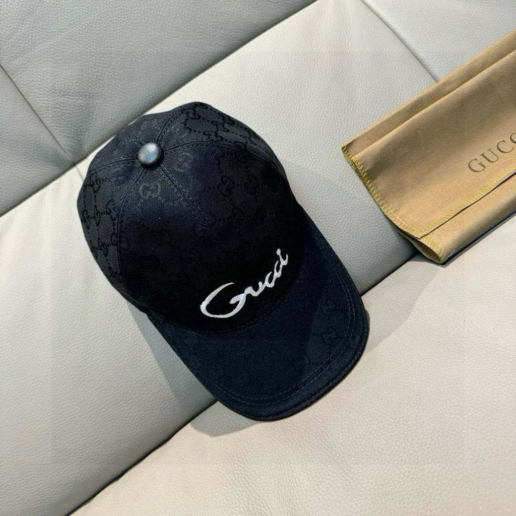 Gucci cap in dark GG monogram fabric with white script logo and button