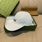 White GG monogram baseball cap with black cursive logo on side panel