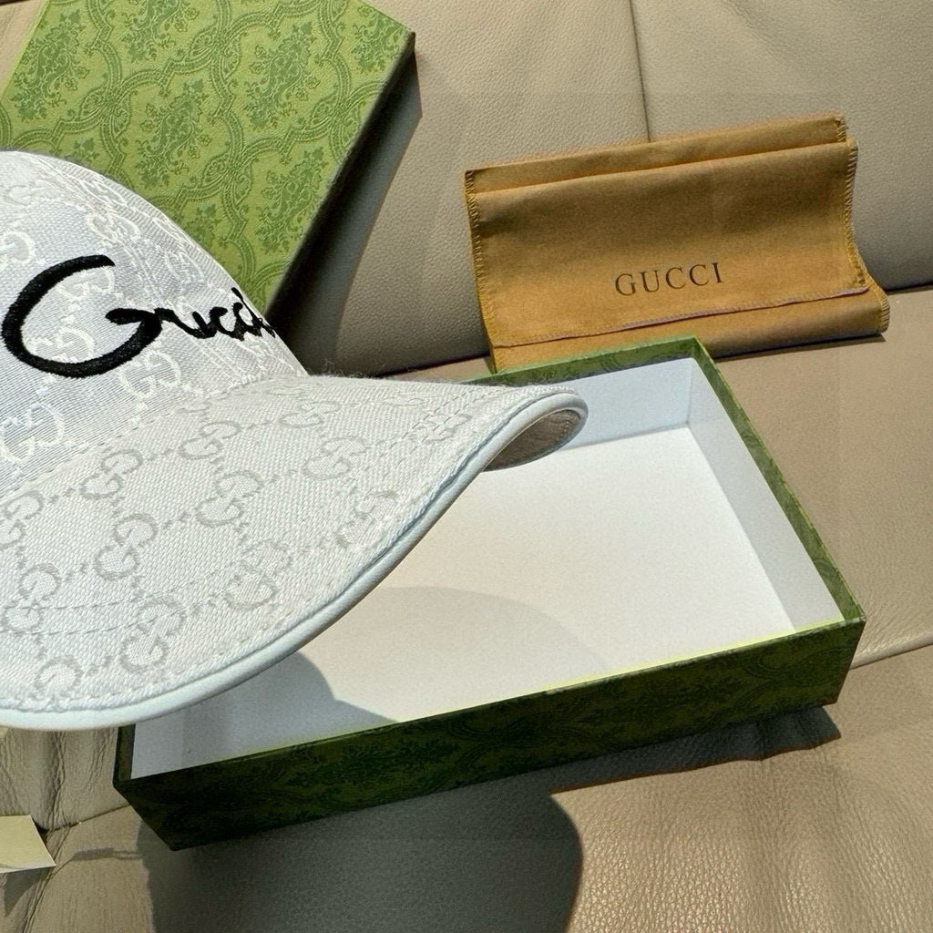 White GG monogram baseball cap with black cursive logo on front