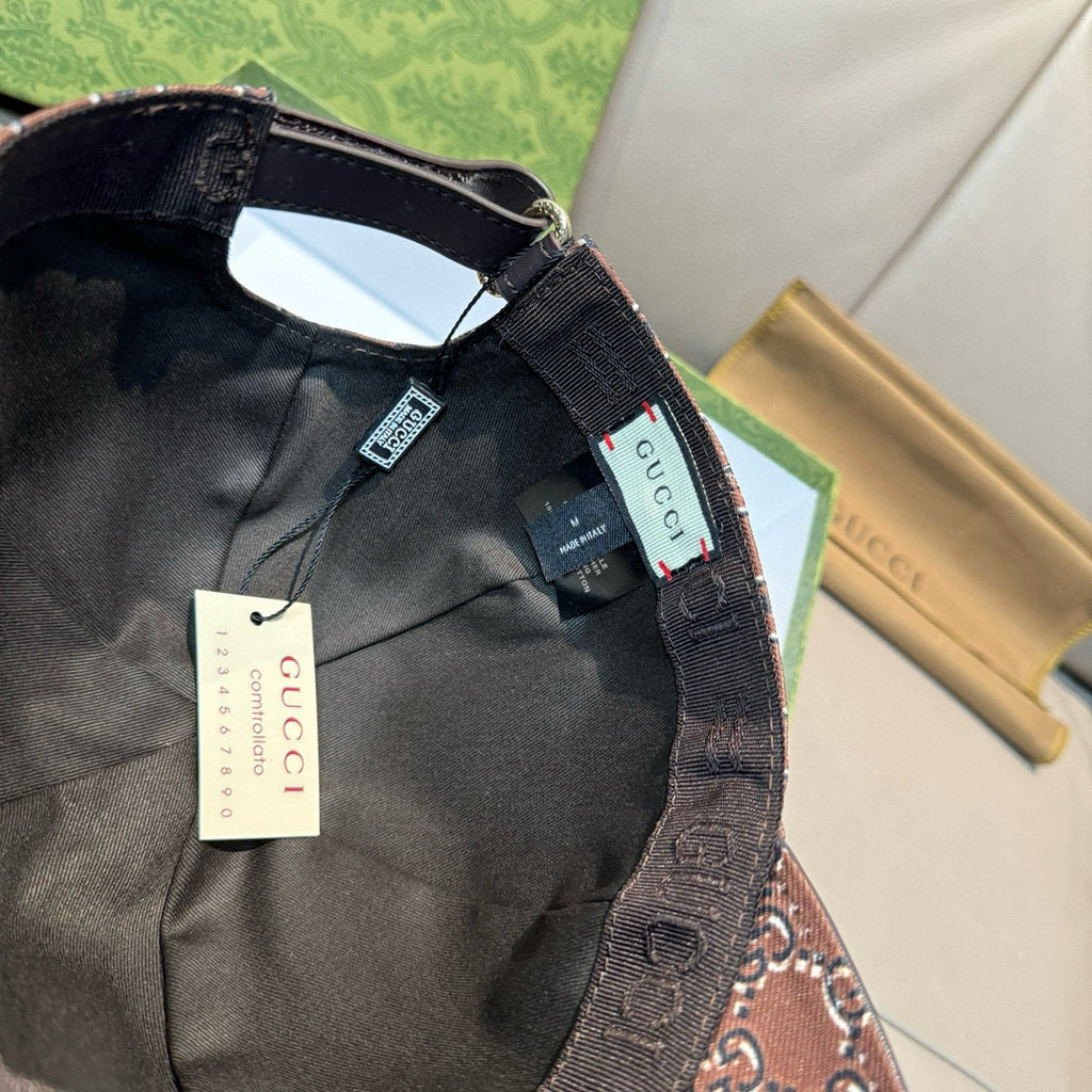 Black Gucci baseball cap interior view with black lining and adjustable strap.