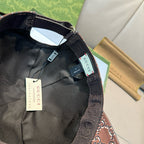 Black Gucci baseball cap interior view with black lining and adjustable strap.