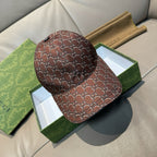 Brown Gucci baseball cap with allover GG-style monogram pattern and curved brim.