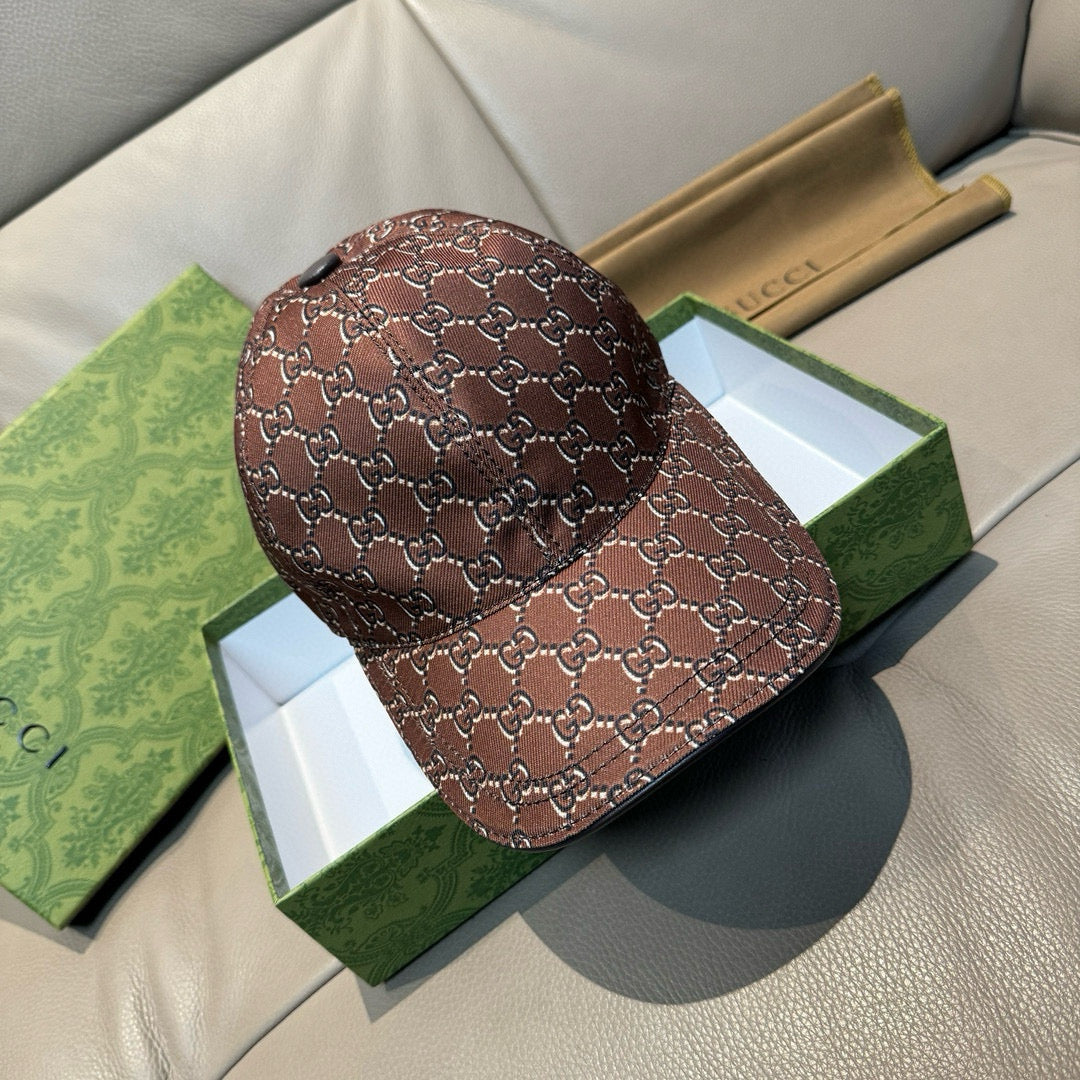 Brown Gucci baseball cap with allover GG-style monogram pattern and curved brim.