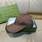Brown Gucci baseball cap, side view, with GG-style monogram pattern and curved brim.