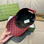 Burgundy GG-pattern cap with black interior lining and size tag