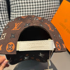 Louis Vuitton cap with white logo label on inside back and dark brown monogram