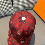 Red Louis Vuitton cap with allover monogram icons, eyelet vents, and stitched seams