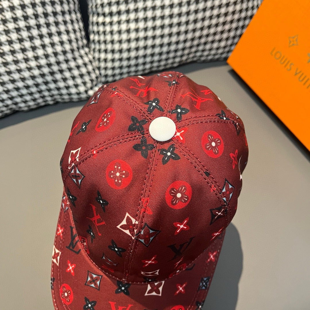 Red Louis Vuitton cap with allover monogram icons, eyelet vents, and stitched seams