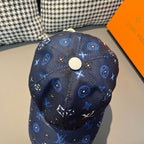 Louis Vuitton navy patterned baseball cap top view with white snap button and monogram motifs