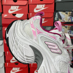 White sneaker with pink collar lining, lace-up front, and chunky layered midsole