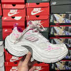 White and pink lace-up sneakers with rounded toe and thick sculpted midsole