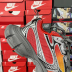 Red mesh sneaker with gray overlays, cushioned heel, and gray lace-up closure