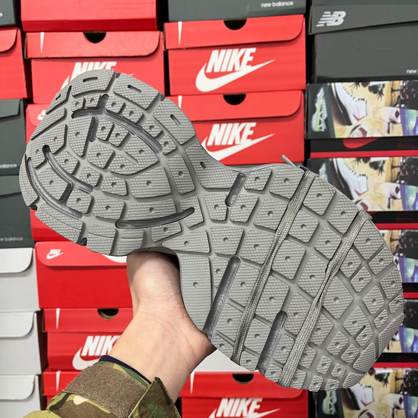 Gray rubber sneaker outsole with deep tread pattern