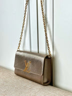 Small beige textured crossbody bag with LV-style logo and gold chain strap