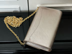 Beige textured crossbody bag with gold chain strap, flap logo detail