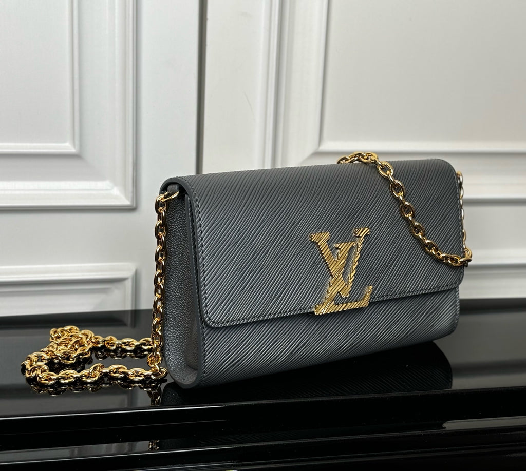 Louis Vuitton flap crossbody bag in dark blue-gray with gold LV monogram and chain strap