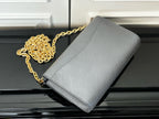 Louis Vuitton crossbody bag in light blue-gray with gold chain strap, angled view
