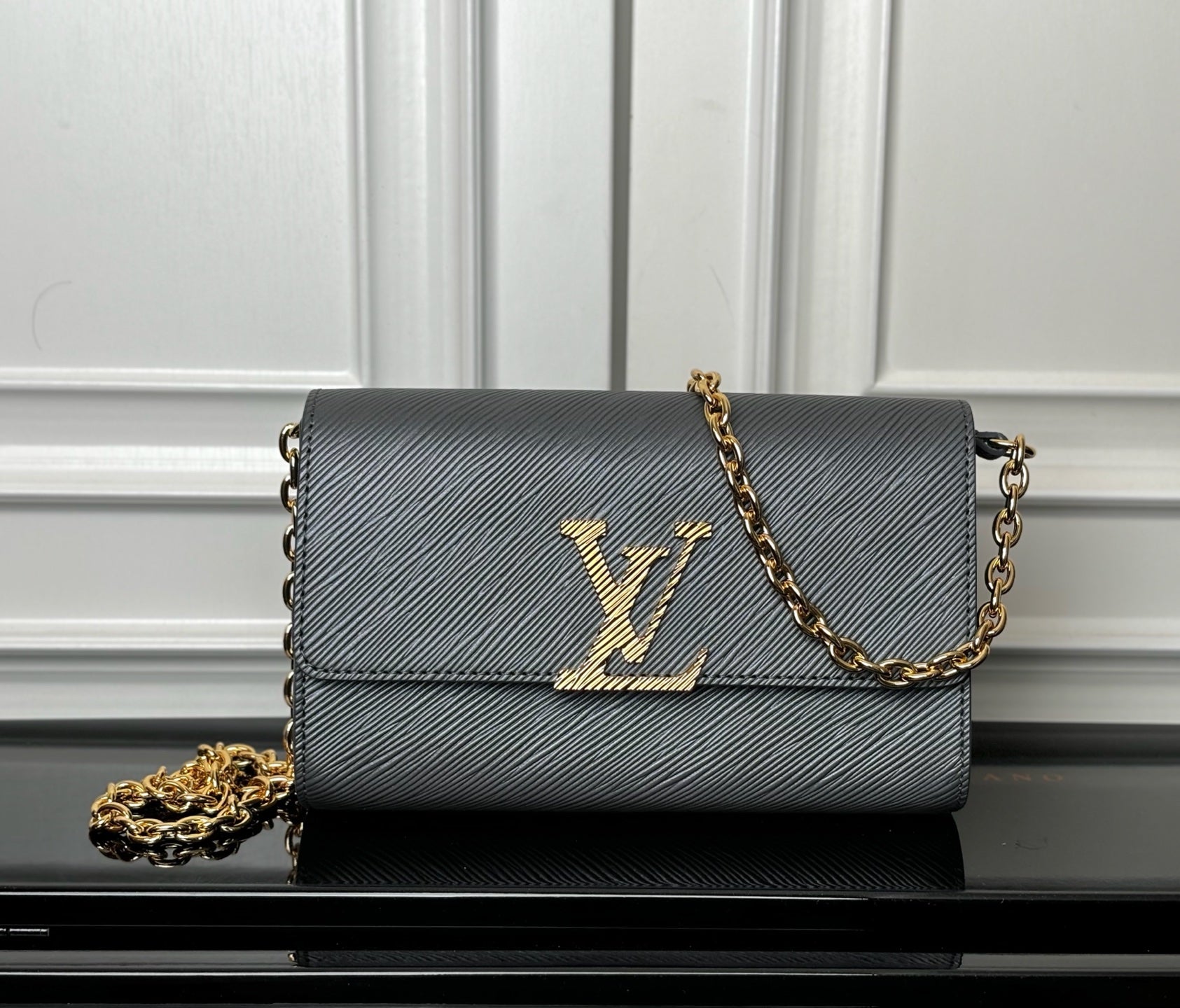 Louis Vuitton crossbody bag in dark blue-gray with gold LV monogram and chain strap