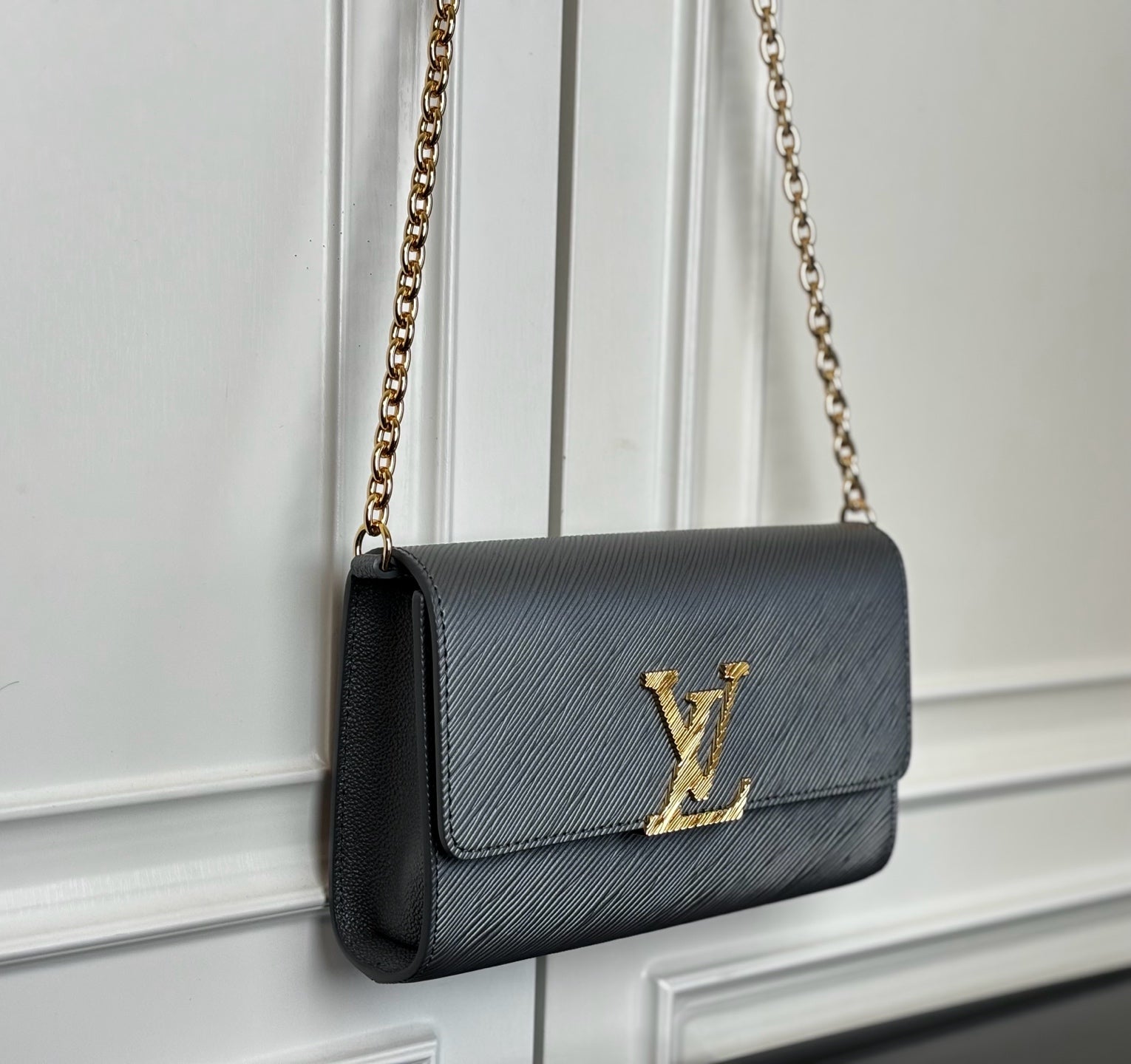 Louis Vuitton crossbody bag in black with gold LV monogram and chain strap